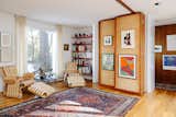 Once the children's playroom, the sitting area can be made private with an articulating cork wall, original to the home. 