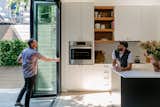 Glass folding doors from Panoramic Doors reach nine-and-a-half feet high to open the kitchen to the courtyard. "It's such a unique feature, especially in Brooklyn," says Slocum. "You rarely ever see that type of thing."