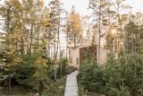 An open-air boardwalk carries the family west from the gathering spaces to their bedroom cabin.