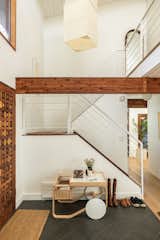Inside the waffle front door, a common feature of Deck Houses, are an Artek Tea Trolley 900 by Alvar Aalto with a ceramic vase by Femme Sole and Home Union.