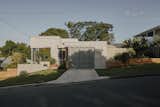 A new compressed fibre cement sheet and metal enclosure wraps the home.