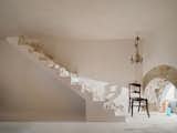 In the guest suite is a staircase that goes nowhere. Eva initially wanted to connect the space to her bedroom above but changed her mind. "I told the workers, ‘Leave the stairs,’ " she says. "Then I started to put some stones and pieces of leftover chaux. It’s full of objects that aren’t really anything."