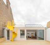 Vine Architecture Studio reimagined a top-floor East London apartment to include a vibrant yellow spiral staircase that links the upper and the lower terraces. "The stair is minimal yet carefully detailed," says architect Rory Pennant-Rea. "We designed it to be seen as an external sculptural element."