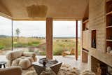 Hutch Design used organic materials and earthy tones to transform a pig shed into a home outside London. "Internally we placed an emphasis on crafted, organic materials with earthy tones—including clay-plastered walls and ceilings, end-grain flooring, and English elm joinery—and styled with pieces from artisans and makers," says the firm.