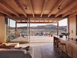 Inside this 1,930-square-foot structure, the full-time residence of Heather Day and Chase McBride, concrete floors and pale woods mimic the outdoor palette. A sliding glass wall from Fleetwood opens to an expansive patio and perfect sunset views.