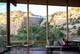 The retreat is designed with rugged material like Cor-Ten steel, split-face concrete block, and cedar that blend with the desert landscape.&nbsp;